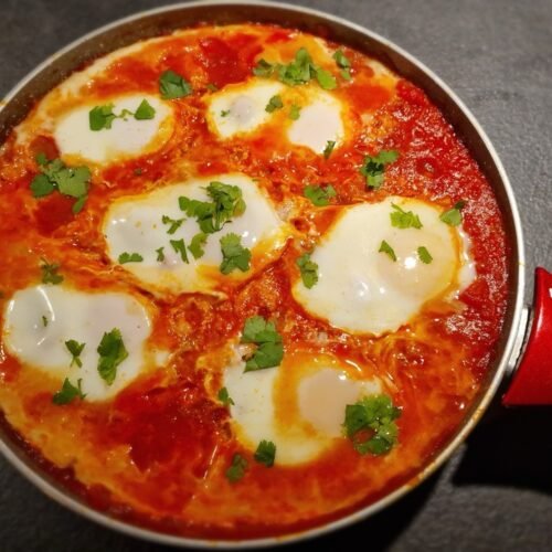 International shakshouka med pocherede æg i en pande